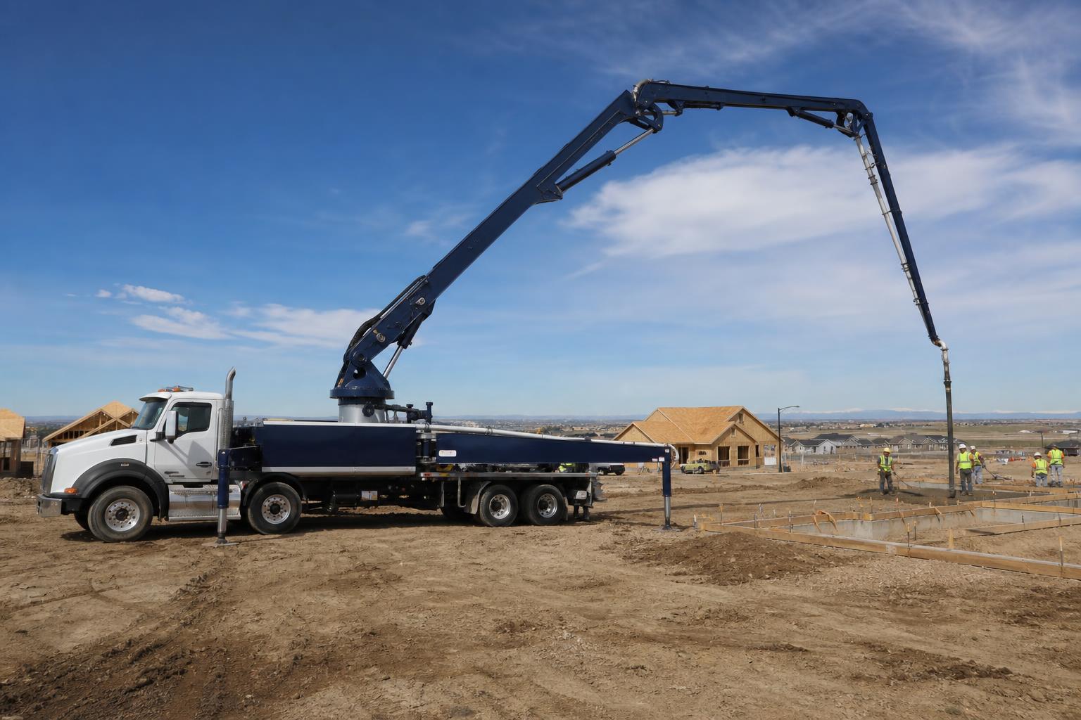 Concrete line pump trailer staged at a residential construction site in the Aurora, Colorado area.